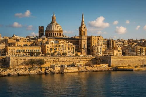 Valletta dome and spire above the fortification walls at golden hour
