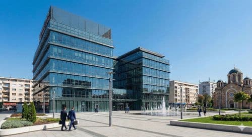 Modern glass office block on an open plaza